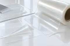 Protective film being lifted from a brushed stainless panel, with coated film rolls alongside
